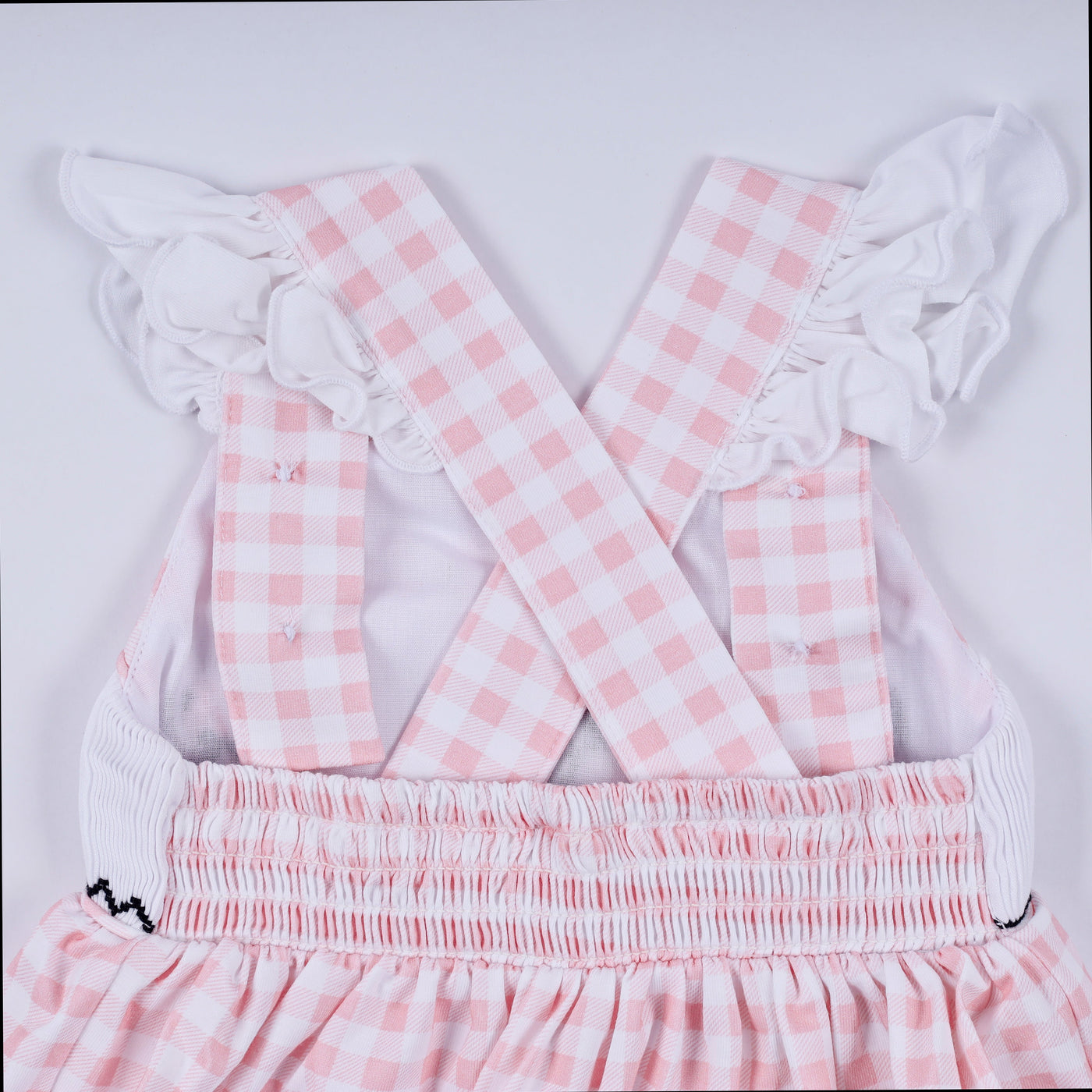 Pink character hand smocked gingham ruffle bubble